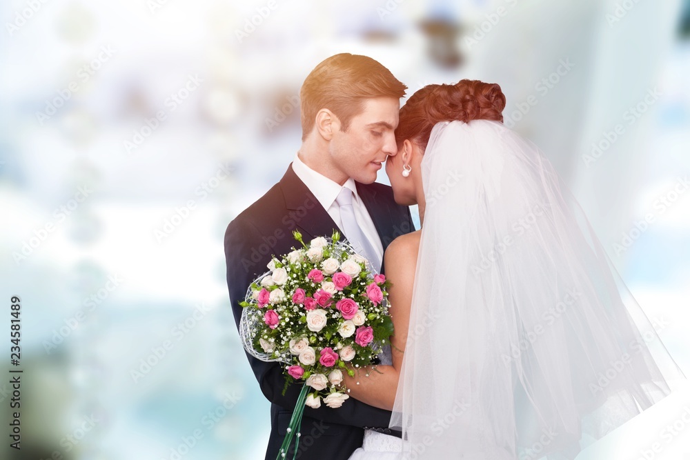 Bride and groom holding stylish bouquet during wedding ceremony