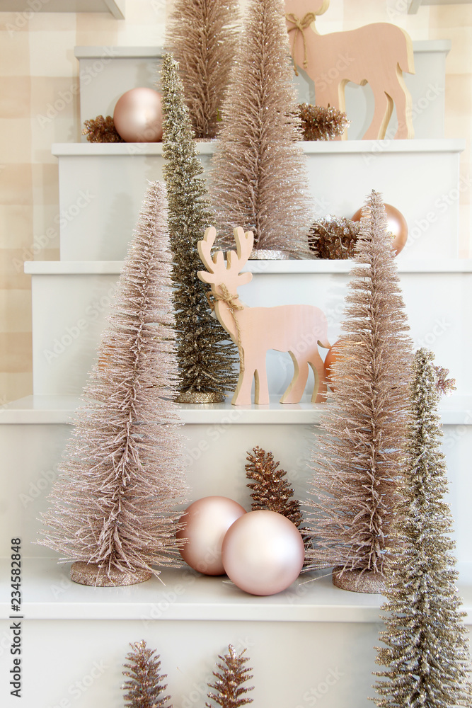 Wooden reindeer and Christmas tree ornament display.