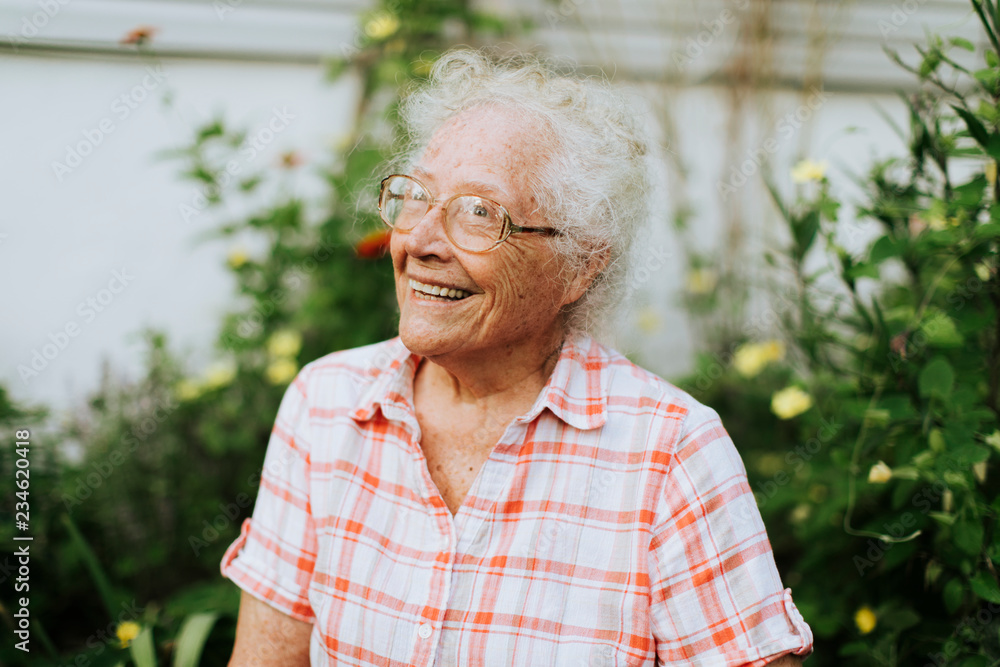 Happy senior woman in her garden