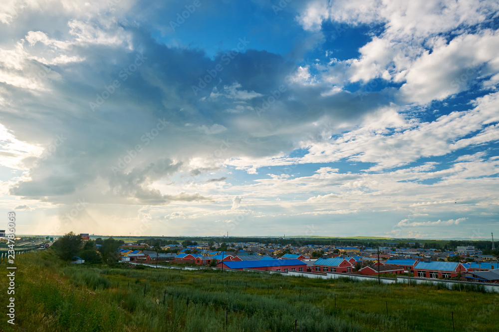 The beautiful cloudscape and town on the grassland.