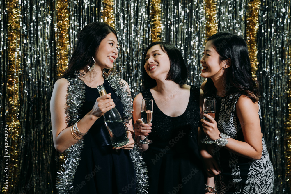 girls drinking glasses of champagne at party