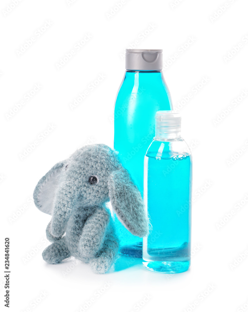 Baby cosmetics and toy on white background