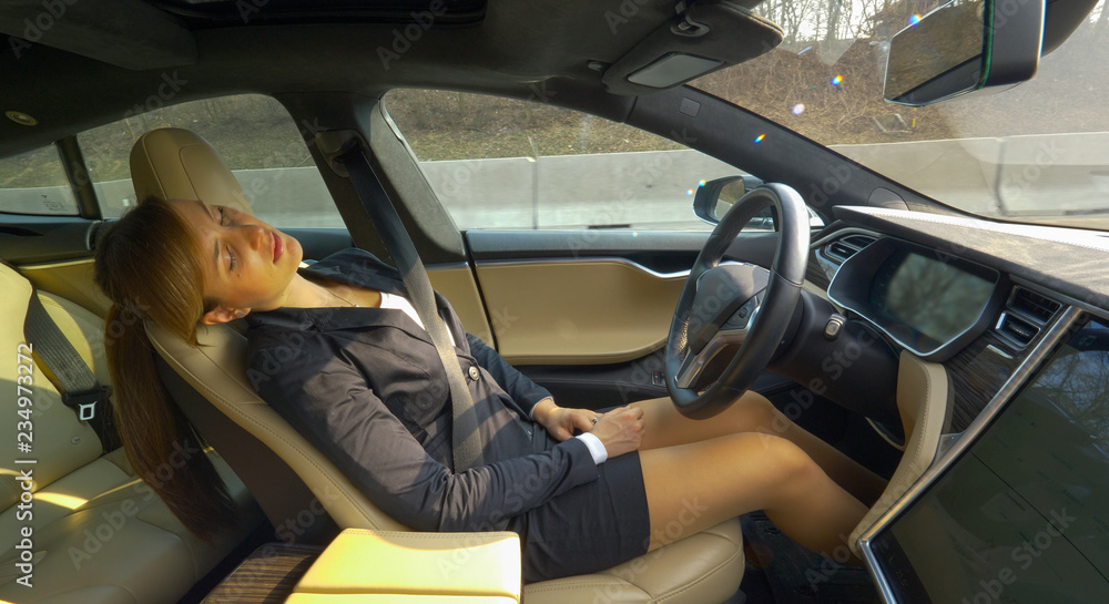 CLOSE UP: Relaxed woman dozes off while autonomous car drives her back home.