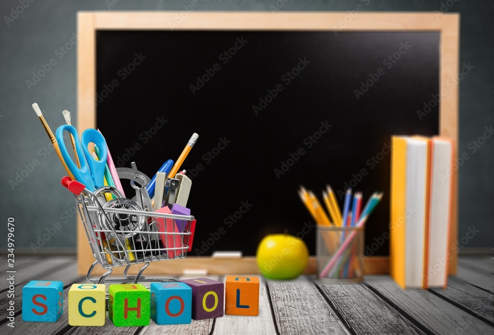 Little blackboard and school supplies on  background