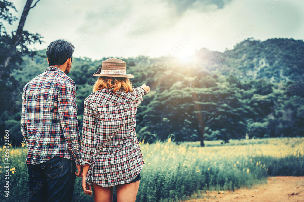 Happy couple take a romantic walk on the hills.