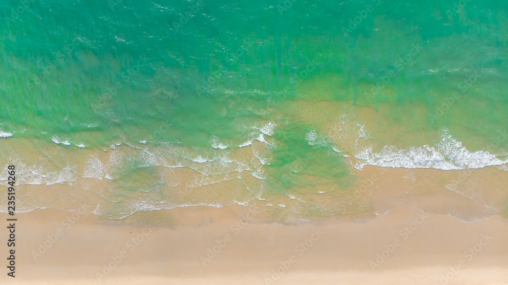 Top view of beautiful sand beach with turquoise sea water,Wave propagation,aerial view from drone ca