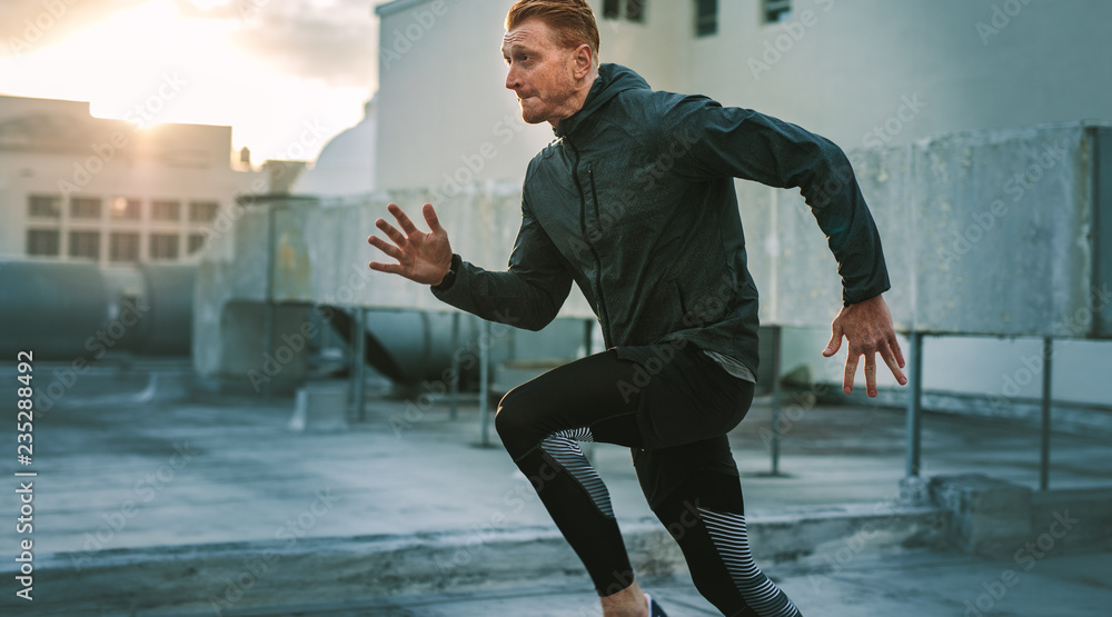 Fitness man doing workout on rooftop