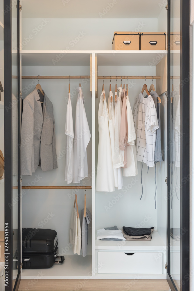 modern closet with clothes hanging on rail