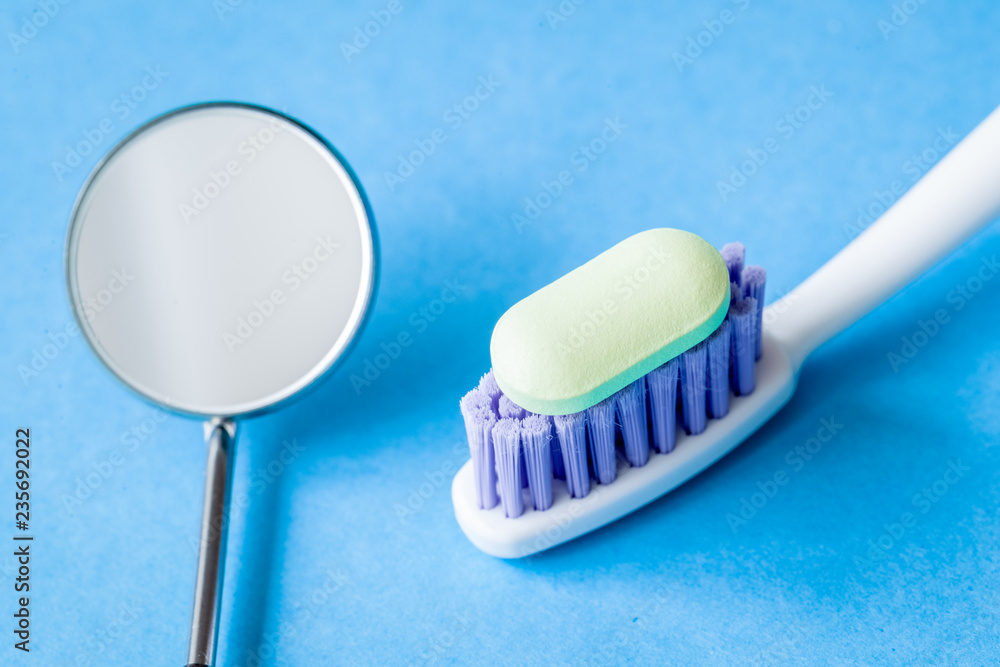 concept tooth pain - dentist tools, tablet at blue background