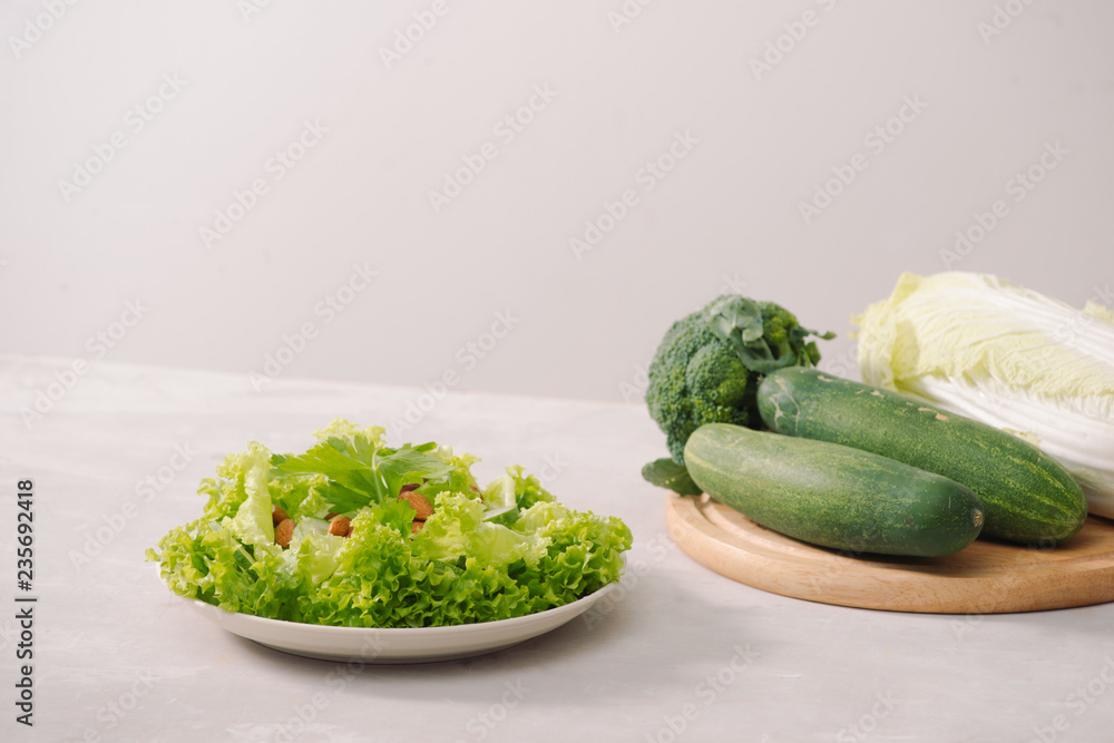 Various green organic salad ingredients on white background. Healthy lifestyle or detox diet food co