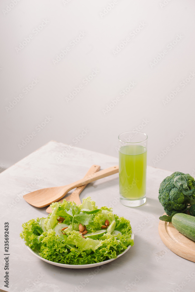 Various green organic salad ingredients on white background. Healthy lifestyle or detox diet food co