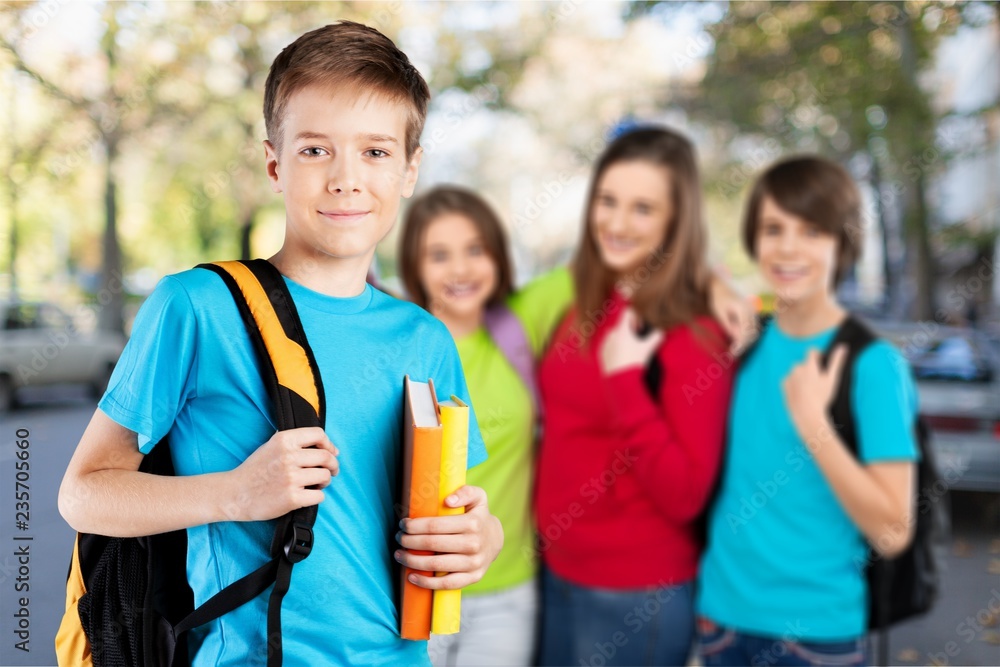 School boy with books and backpack