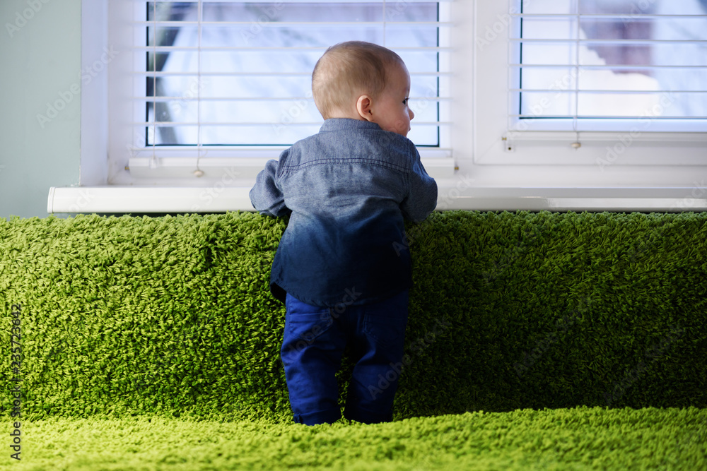 Newborn baby boy portrait on green carpet closeup. Motherhood and new life concept