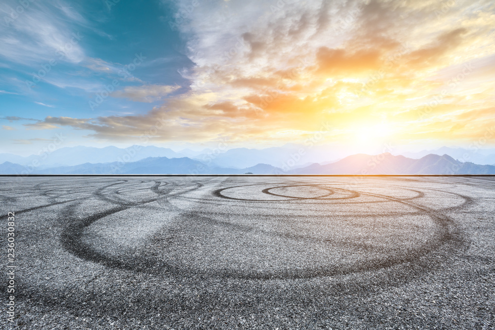 Asphalt road pavement and mountain at beautiful sunset