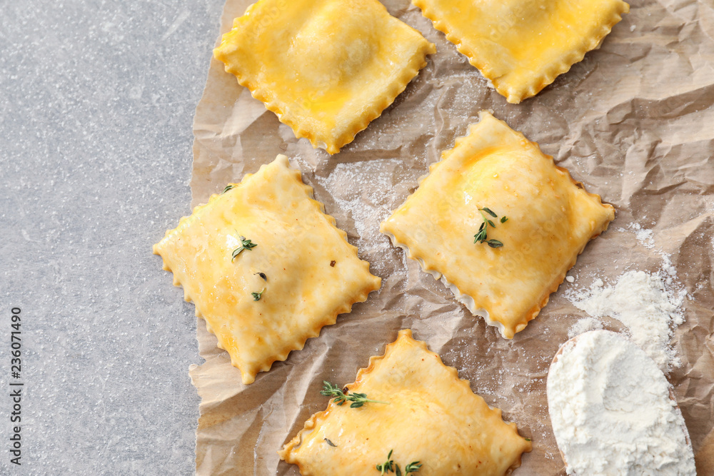 Tasty ravioli on parchment, closeup