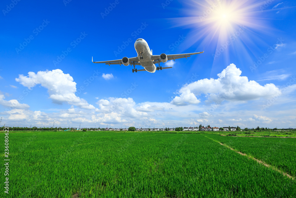 Airplane flying over countryside farmland