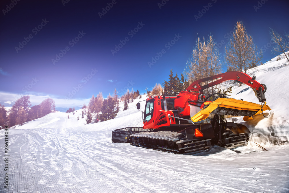 Winter landscape with snow plowing bulldozer. Snow removal equipment for a ski resort