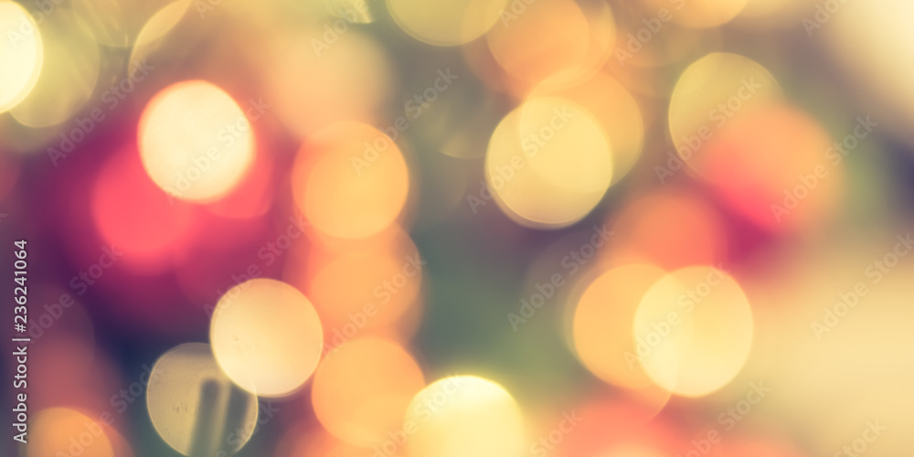 Christmas bokeh blur background with blurry x’mas tree party night light decoration ornate in warm r