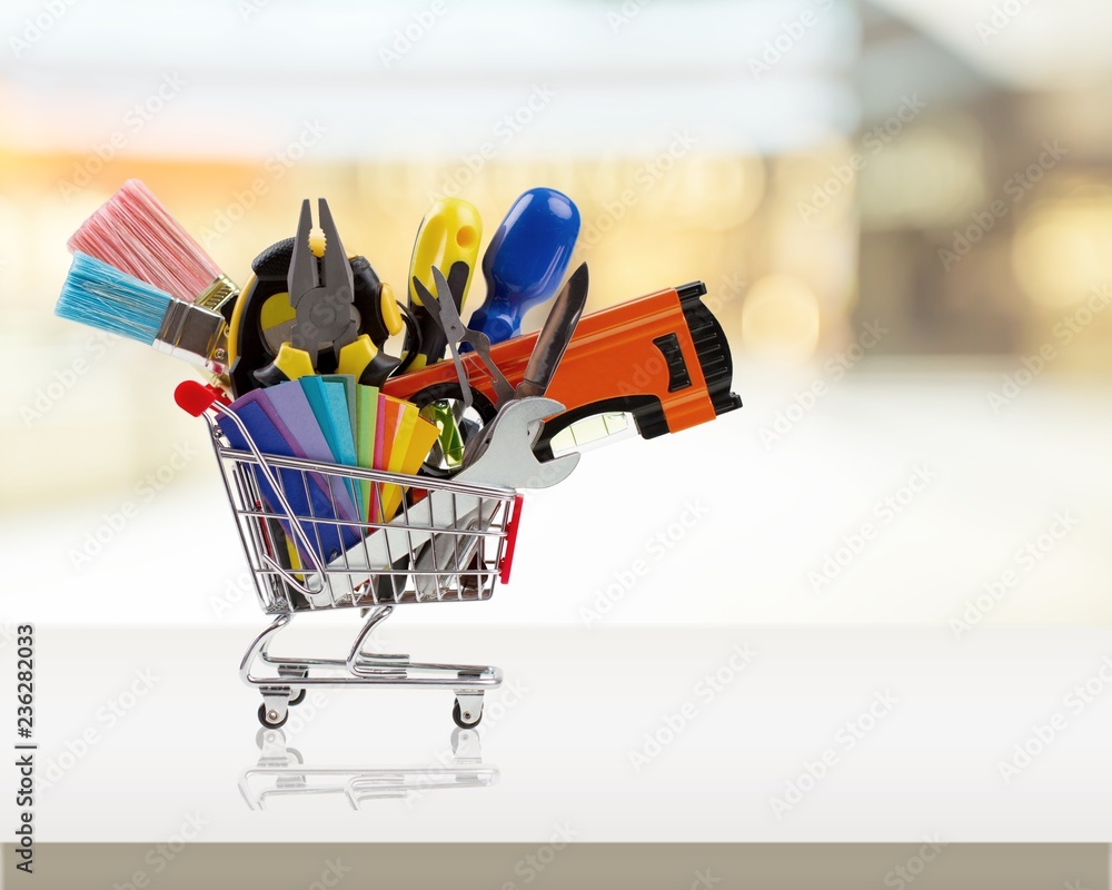 Shopping cart full of construction tools, isolated on