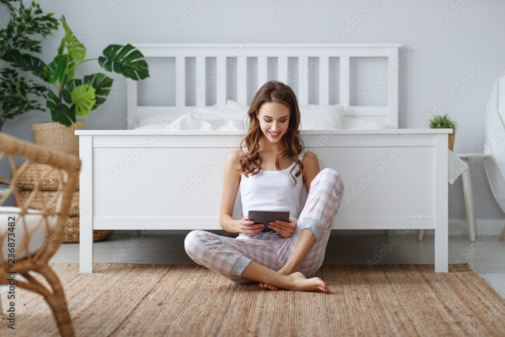 young cute girl with tablet at home in bedroom