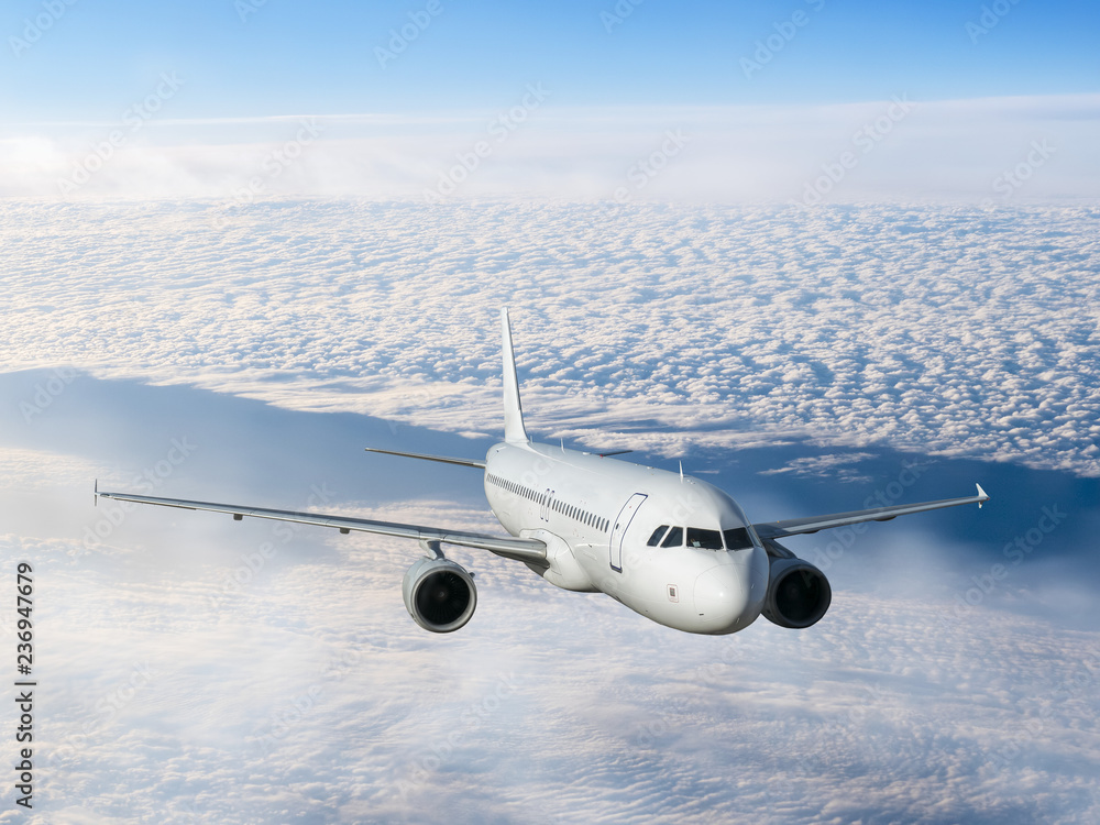 airplane flying over clouds.