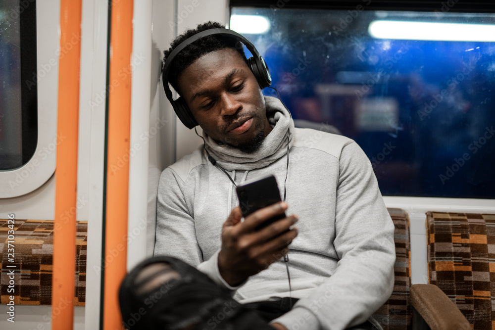 Bored man texting while on the train