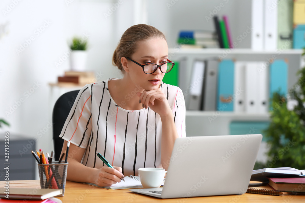 Female student with laptop studying at home