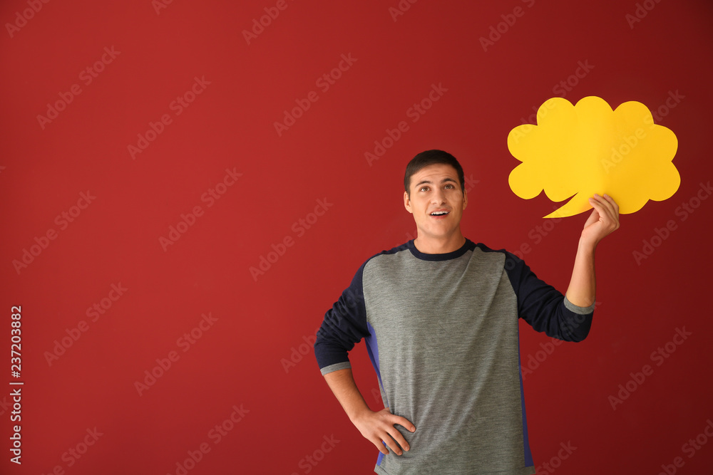 Young man with speech bubble on color background