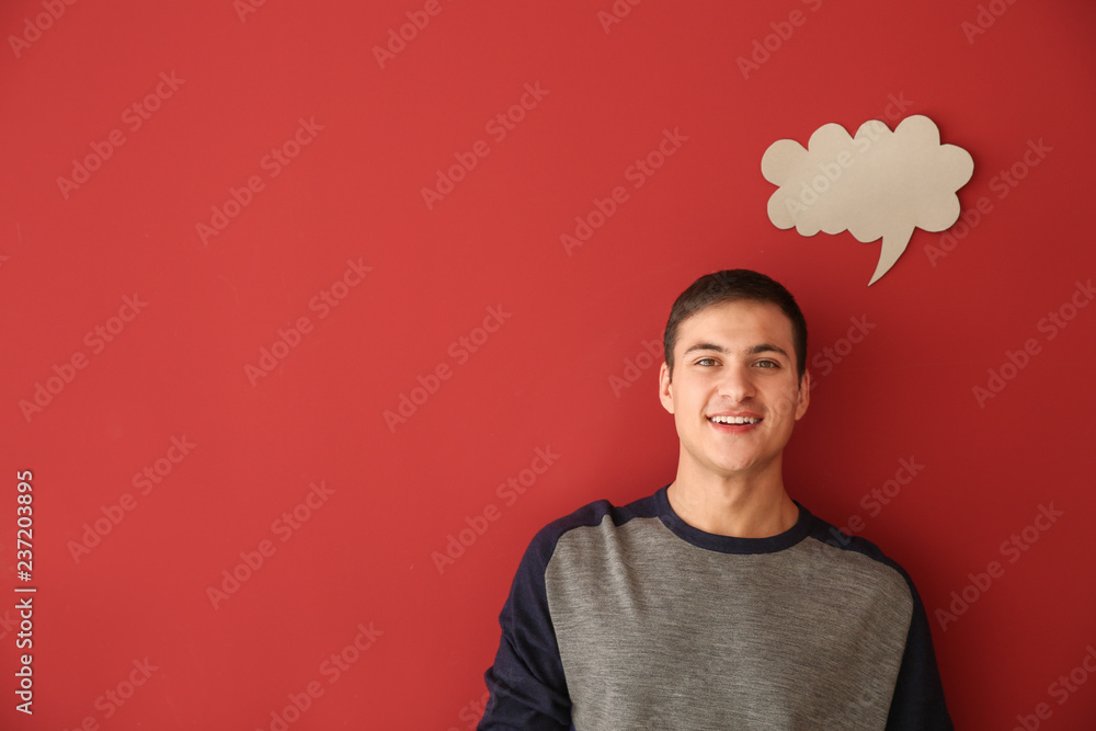 Young man with speech bubble on color background