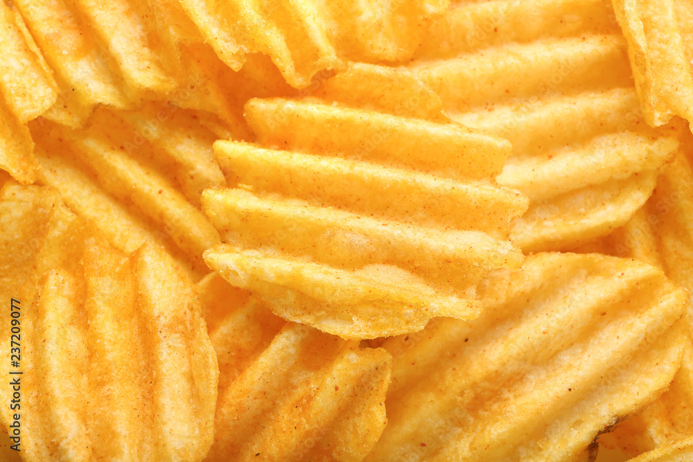 Many tasty crispy potato chips, closeup