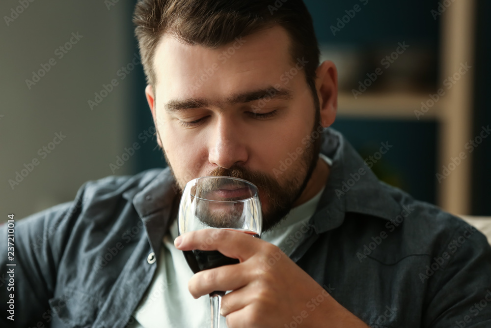 Man with glass of wine relaxing at home