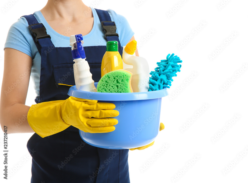 Woman with cleaning supplies on white background