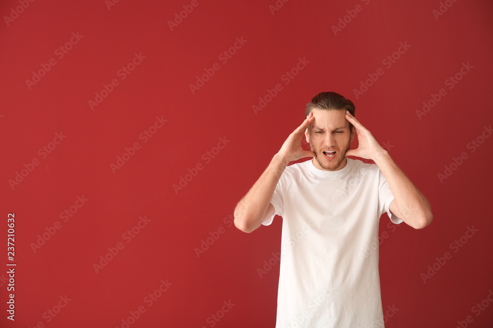 Stressed young man on color background