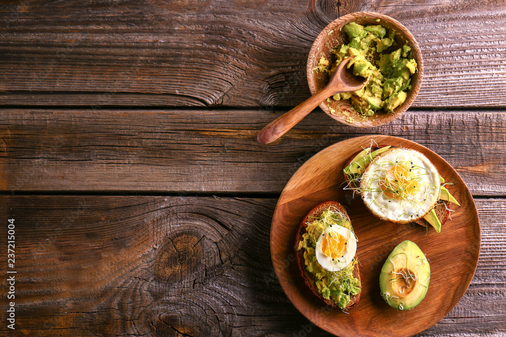 Composition with delicious avocado toasts on wooden table, top view