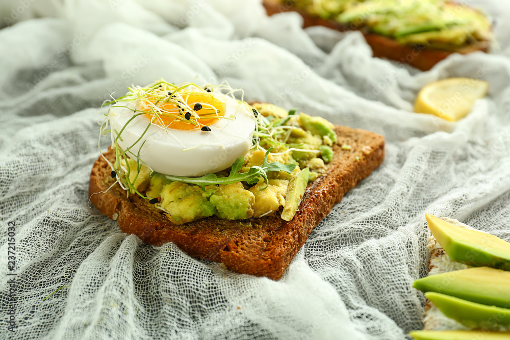 Delicious avocado toast on table