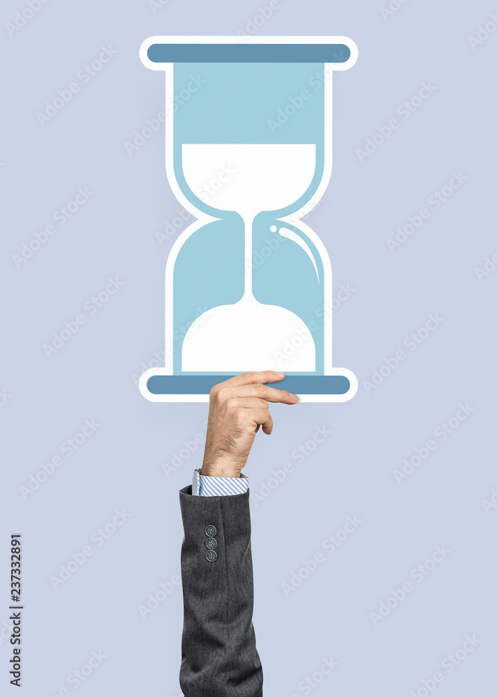 Hand holding an hourglass clipart