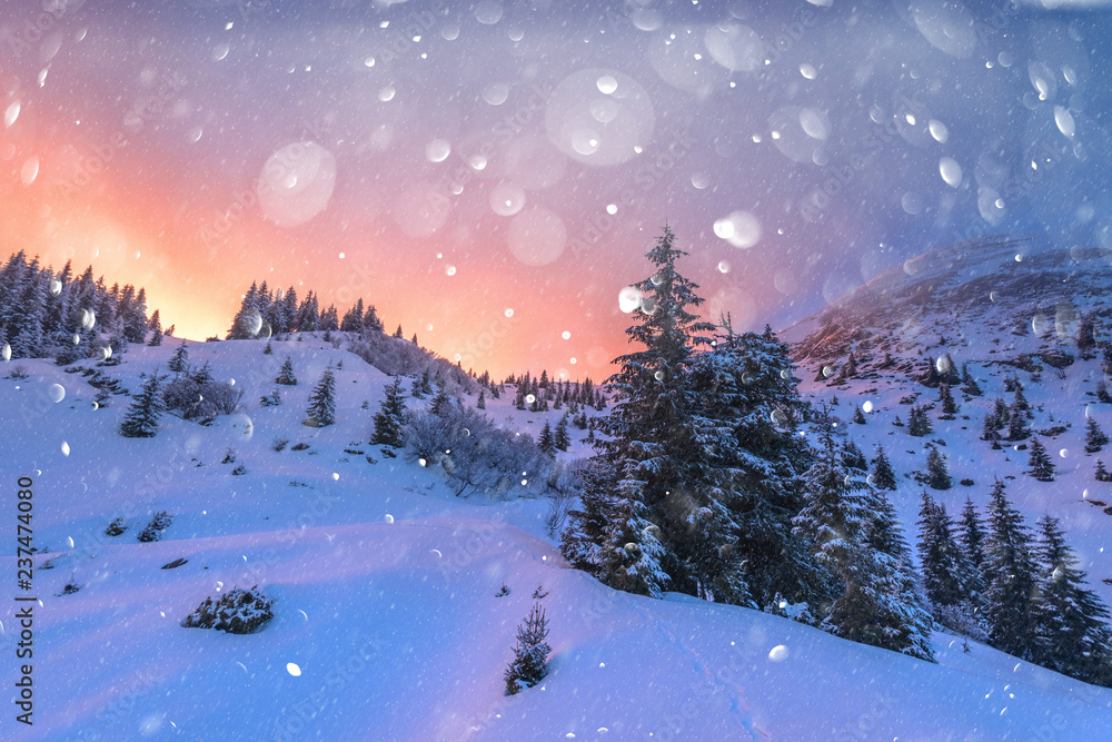 Fantastic orange winter landscape in snowy mountains glowing by sunlight. Dramatic wintry scene with