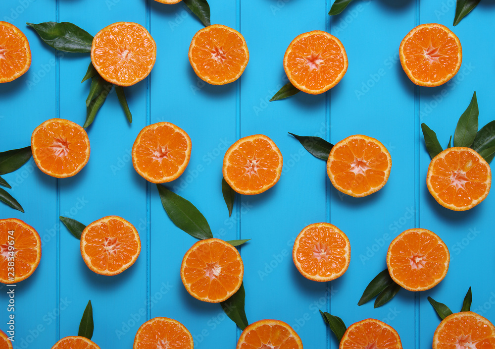 tangerines with green leaves on turquoise  background.