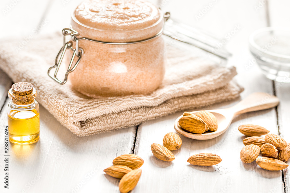 natural scrub with almond oil and sugar on light table backgroun