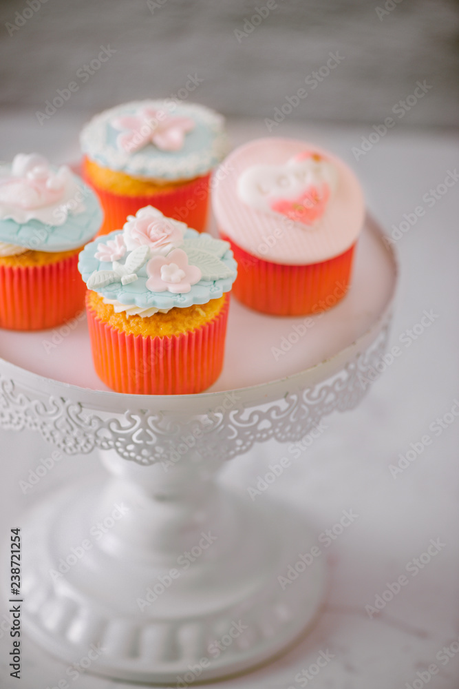 Tasty sweet pink cupcakes. Decorated dessert table