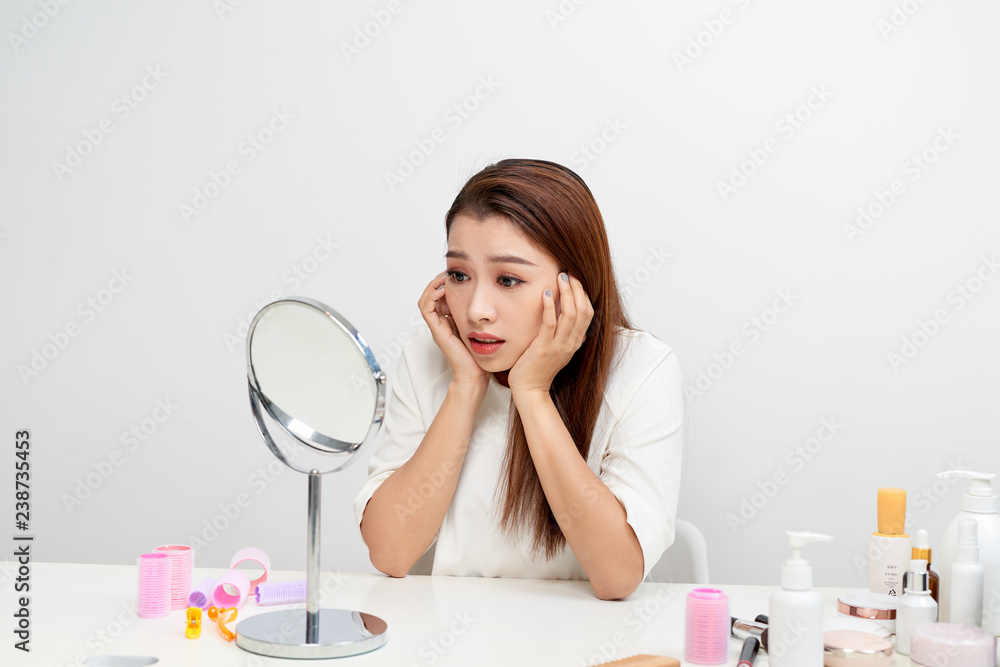 Young woman checking her skin. Skin care concept.