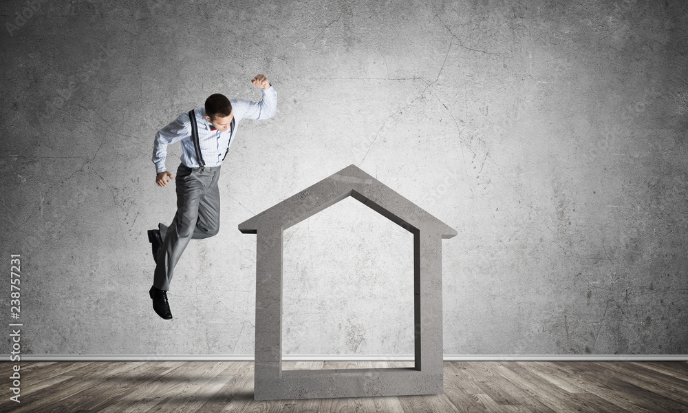 Stone home silhouette in empty room as symbol for real estate insurance