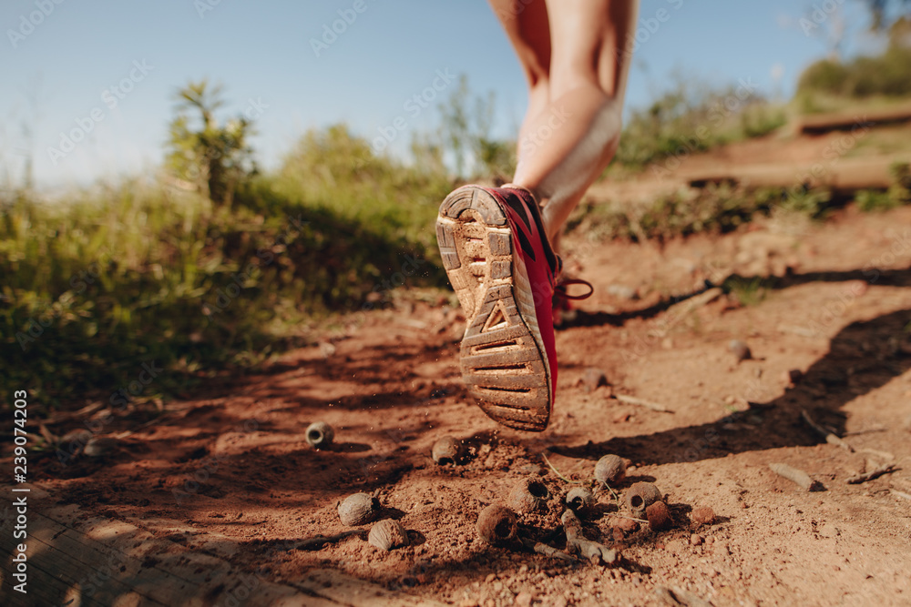 Cropped shot of an athlete walking on a mud trail path