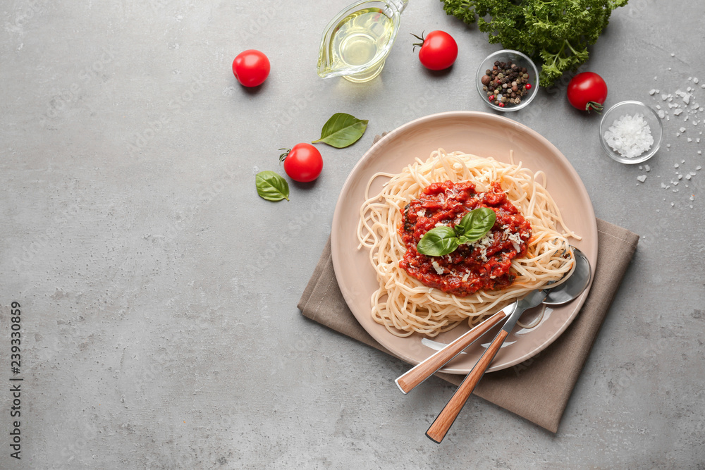 Plate with delicious pasta bolognese on grey table