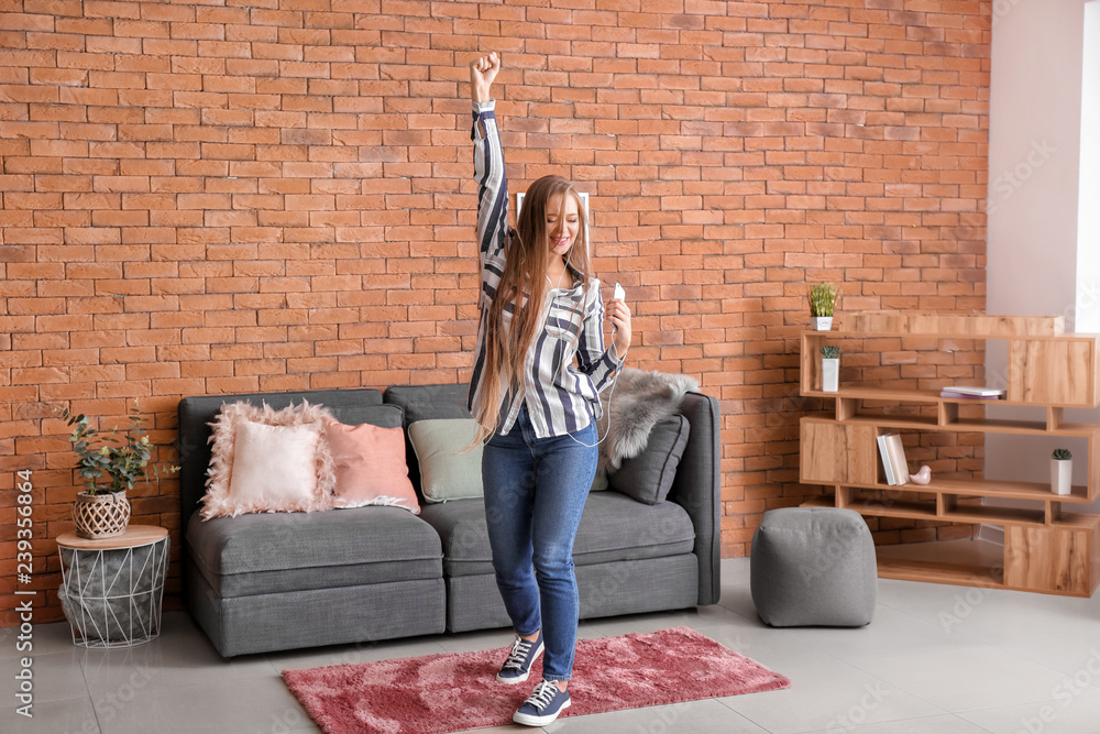 Beautiful young woman dancing at home