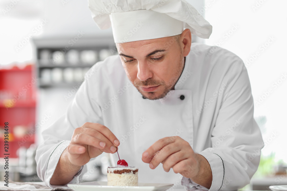 Male chef with tasty dessert in kitchen