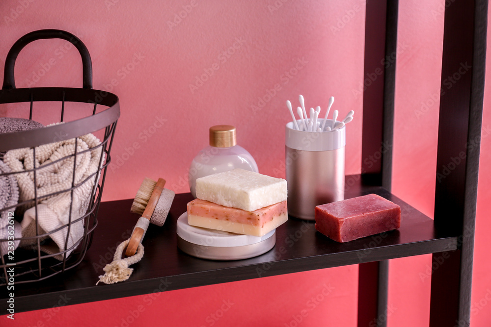 Soap, towels and accessories on shelf in bathroom