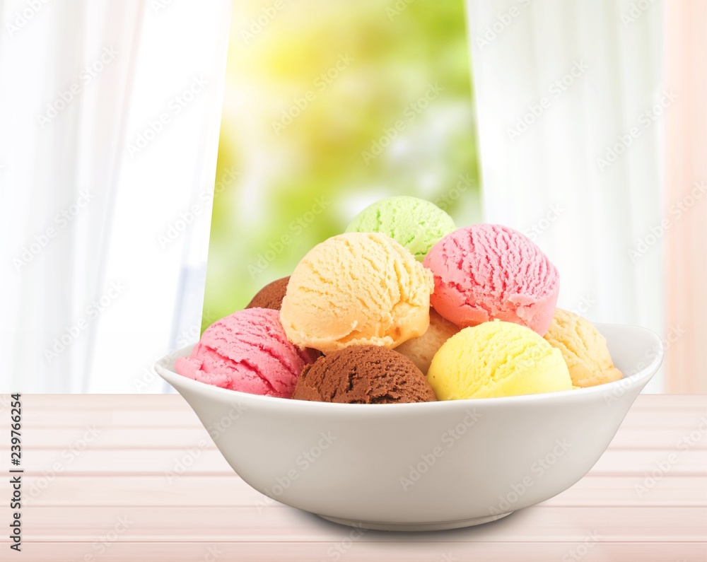 Ice cream scoops in bowl on white background