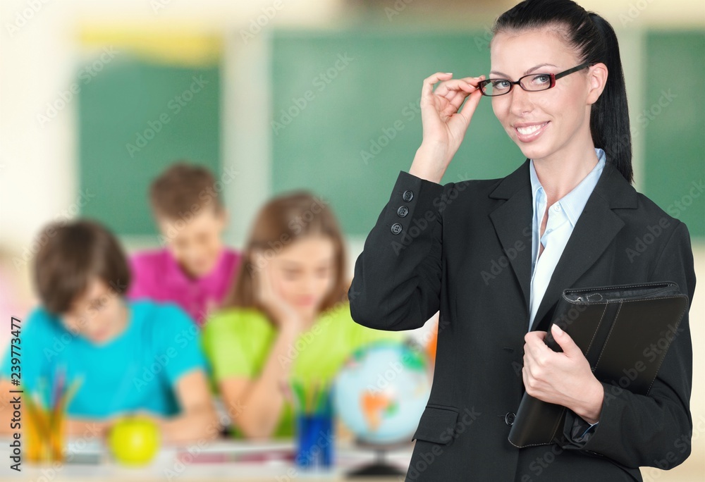 Young female teacher with students in classroom