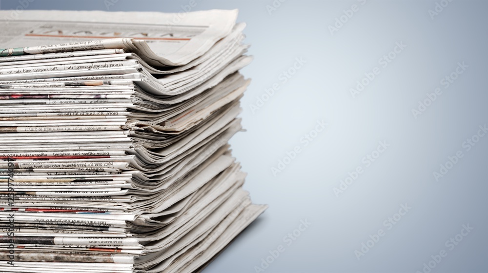 Pile of newspapers on white background